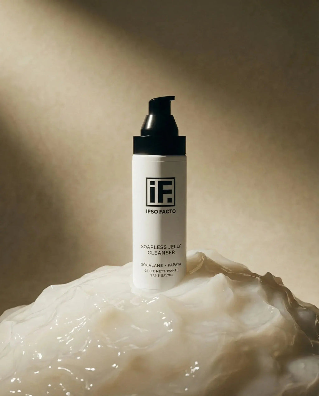 Soapless jelly cleanser bottle on translucent skincare gel with soft lighting