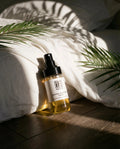 Natural skincare toner bottle on wooden floor, sunlight and palm leaves, clean beauty concept
