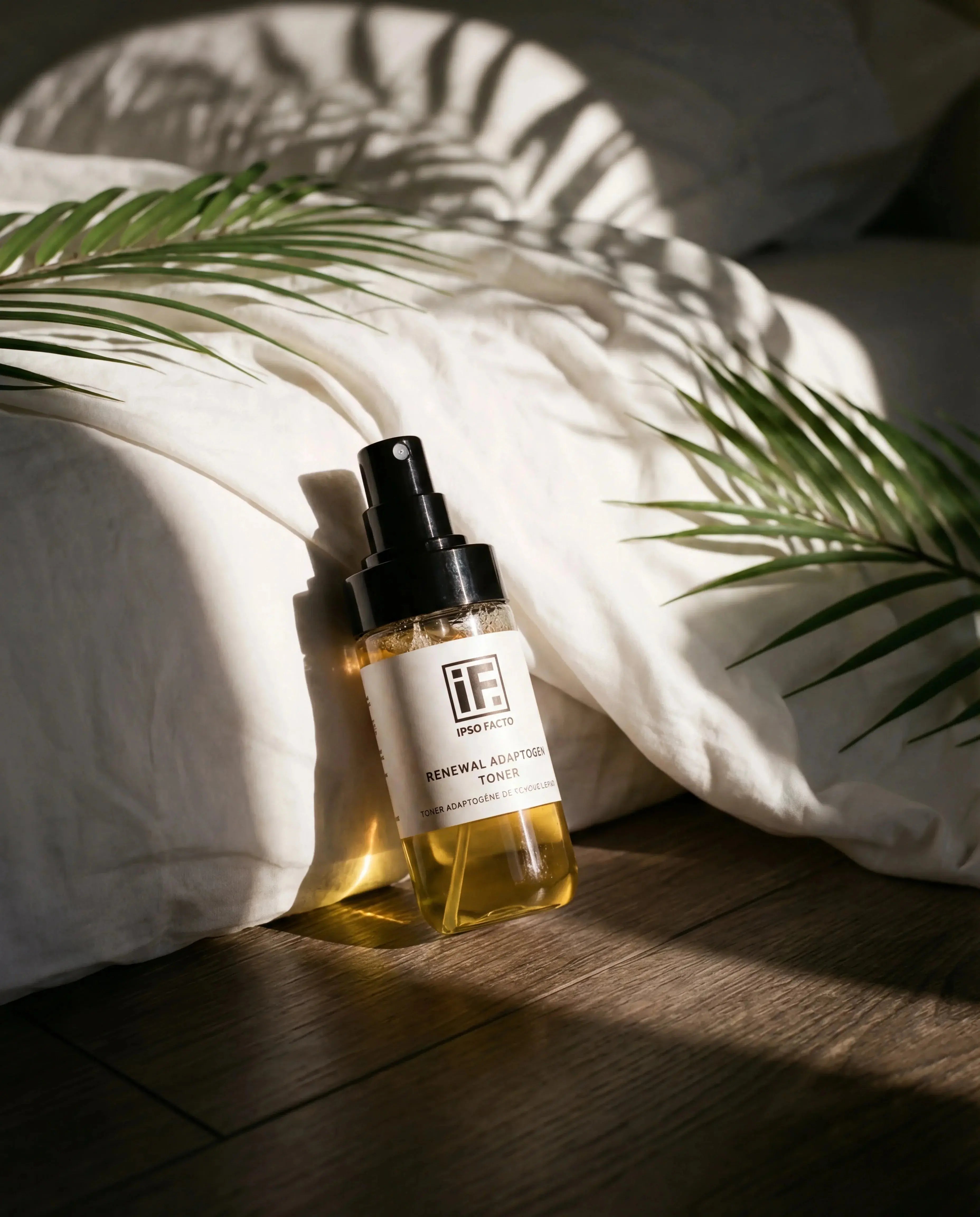 Natural skincare toner bottle on wooden floor, sunlight and palm leaves, clean beauty concept
