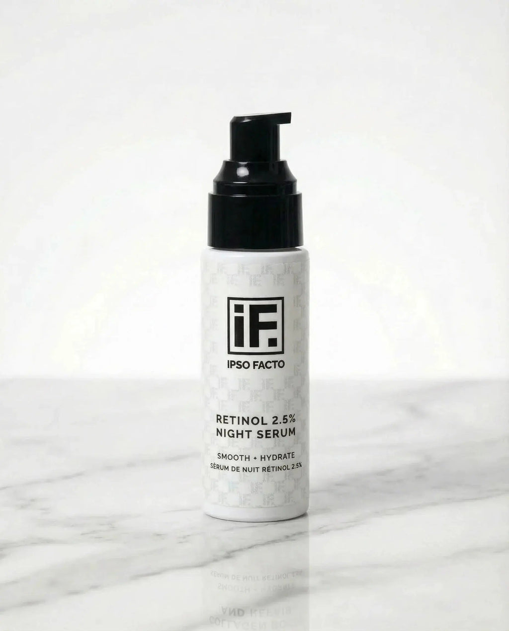 Retinol 2.5% night serum bottle with black pump on marble surface, skincare product