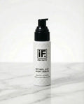 Retinol 2.5% night serum bottle with black pump on marble surface, skincare product