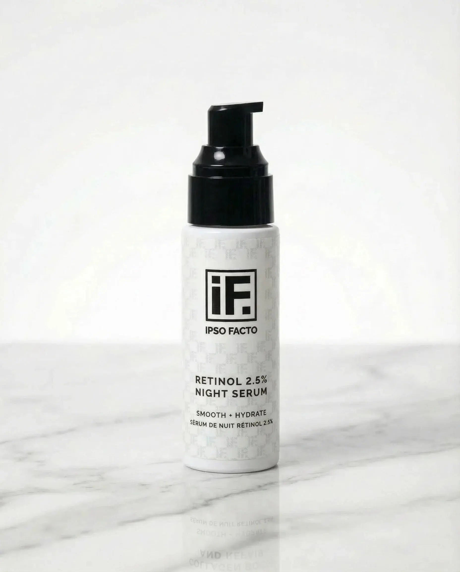 Retinol 2.5% night serum bottle with black pump on marble surface, skincare product