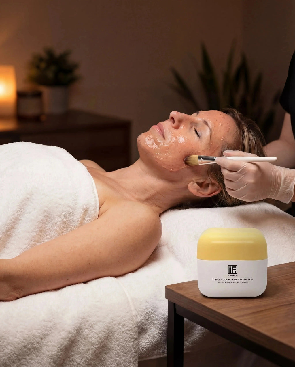 Facial treatment with resurfacing peel applied to woman's face in spa setting