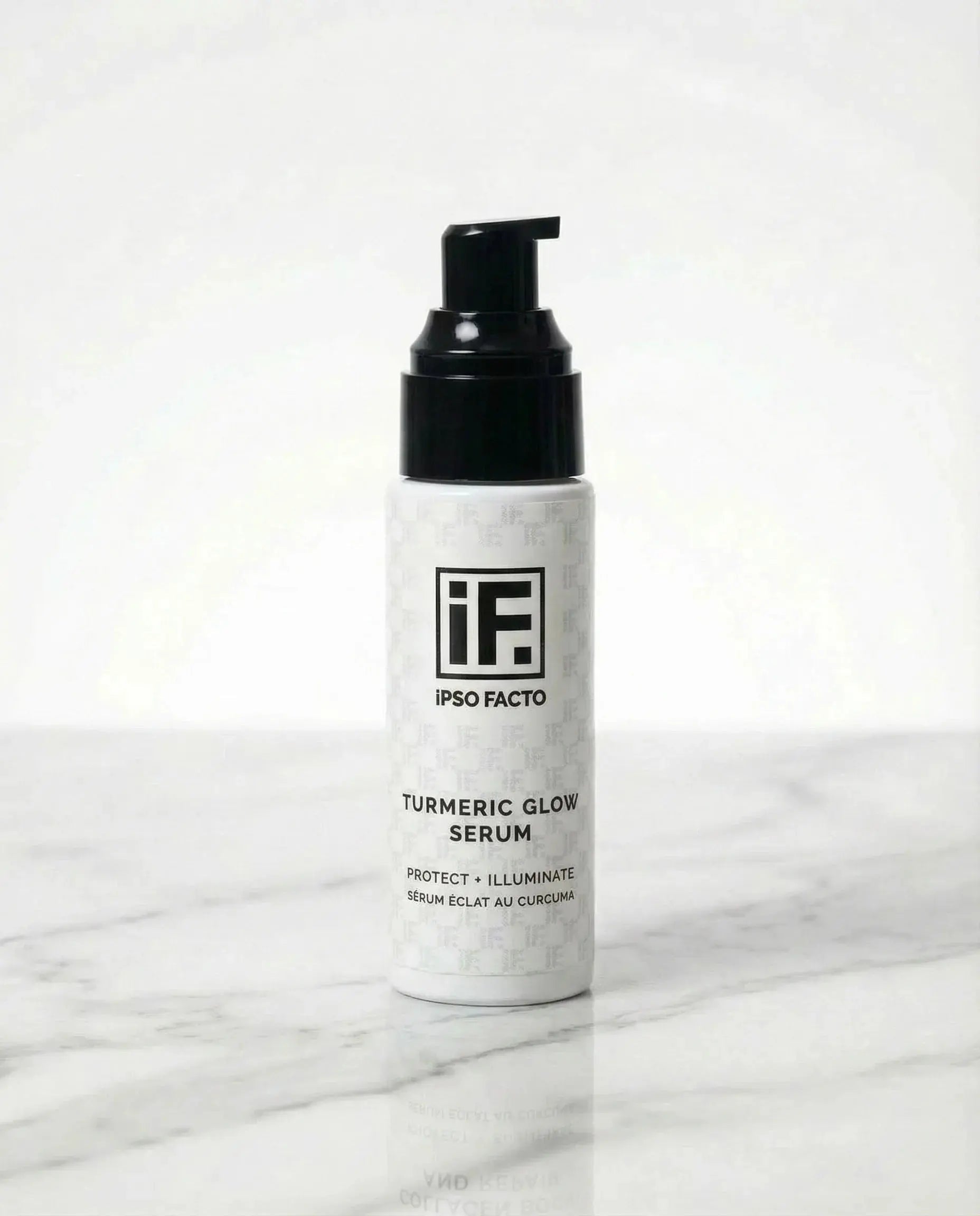 Turmeric Glow Serum skincare bottle with pump on white marble background